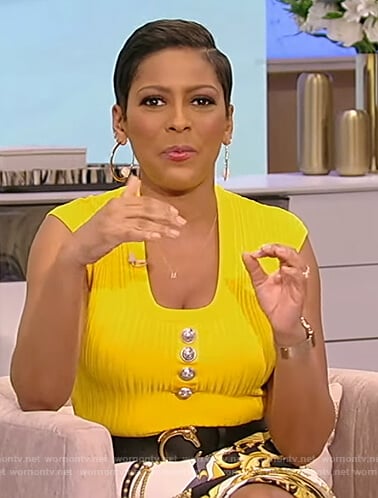 Tamron’s yellow button embellished top on Tamron Hall Show