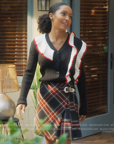 Zoey’s black pleated ruffle cardigan and plaid skirt on Grown-ish