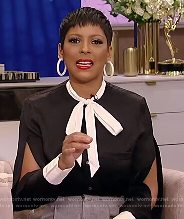 Tamron’s black tie neck blouse with split sleeves on Tamron Hall Show