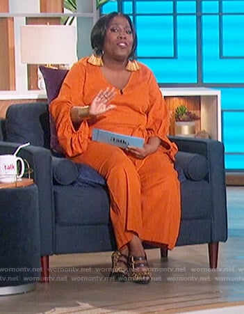 Sheryl’s orange wrap jumpsuit on The Talk