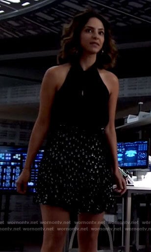 Zari's black tie neck top and metallic skirt on Legends of Tomorrow