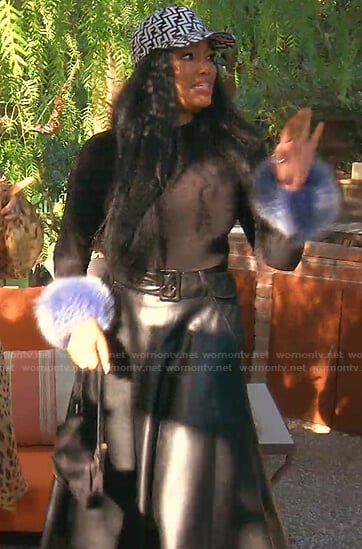 Garcelle's black top with blue feather cuffs on The Real Housewives of Beverly Hills