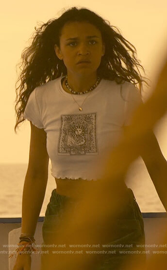 Kiara’s white sun graphic crop top on Outer Banks