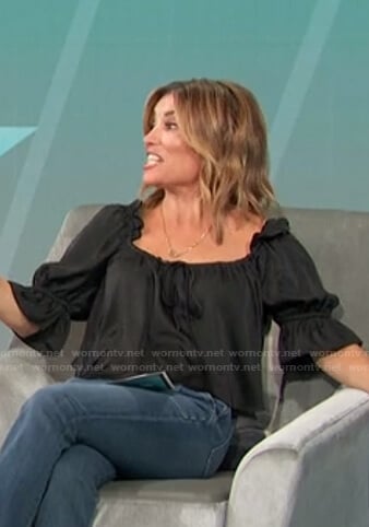 Kit’s black ruffle sleeve top on Access Hollywood