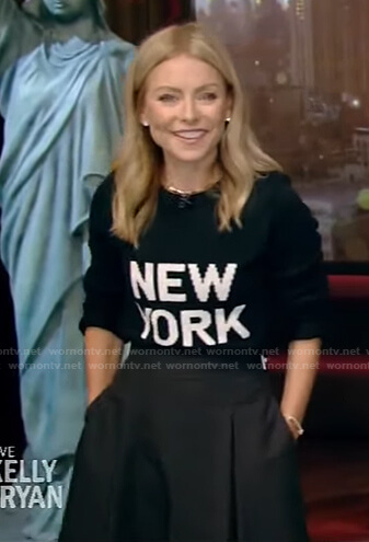 Kelly’s black New York Print sweater and side belt skirt on Live with Kelly and Ryan