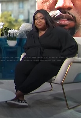 Loni’s black shawl collar jumpsuit on E! News Daily Pop