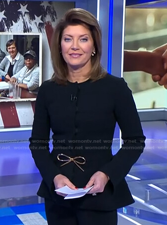Norah's black peplum jacket with bow belt on CBS Evening News