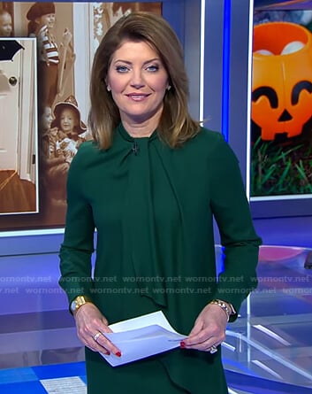 Norah’s green tie neck dress on CBS Evening News