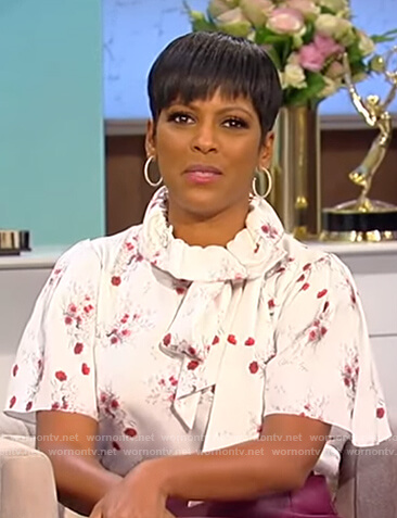 Tamron’s white floral print blouse and purple skirt on Tamron Hall Show