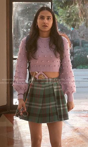Bela's purple pom pom sweater and green plaid skirt on The Sex Lives of College Girls
