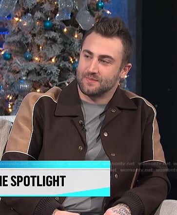 Jordan McGraw’s brown colorblock varsity jacket on E! News Daily Pop