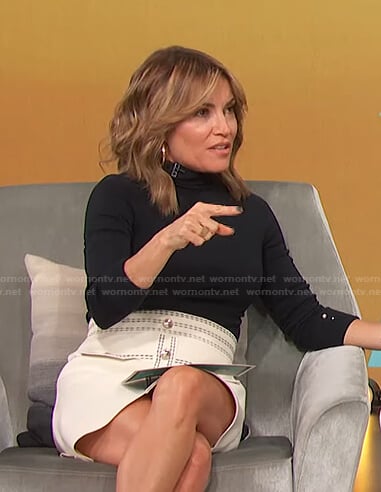 Kit’s black top and white skirt with contrast stitching on Access Hollywood