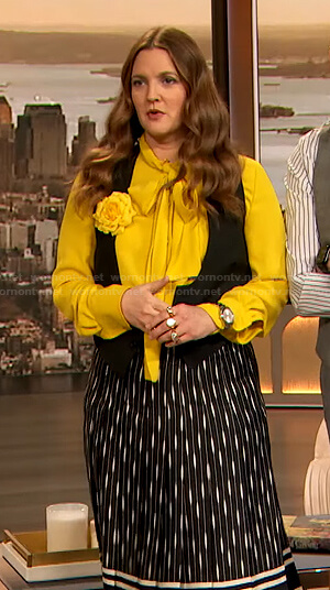 Drew's yellow tie neck blouse and printed midi skirt on The Drew Barrymore Show