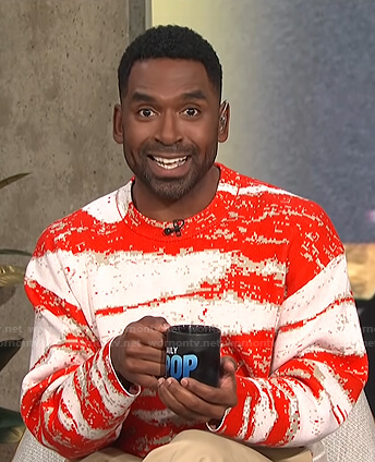 Justin’s red and white abstract print sweater on E! News Daily Pop
