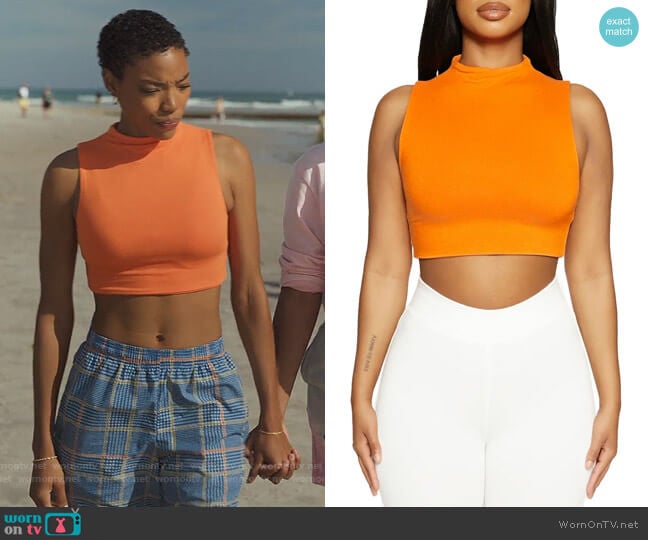 Taylor’s orange crop top on Our Kind of People