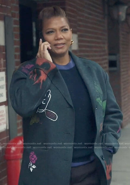 Robyn’s graffiti print coat and heart earrings on The Equalizer