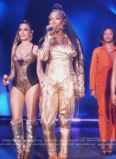 Naomi's gold lace-up jumpsuit on Queens