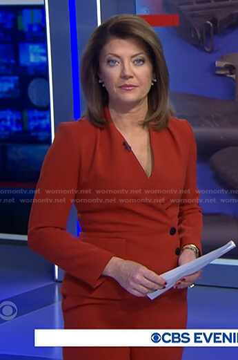 Norah’s red asymmetric button jacket and pants on CBS Evening News