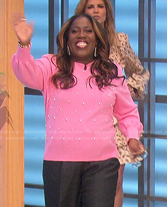 Sheryl’s pink pearl embellished sweater and sneakers on The Talk