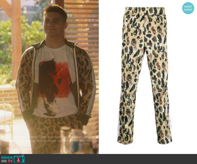 Camouflage-print Track Pants by Palm Angels worn by Vivek Shah (Jordan Buhat) on Grown-ish