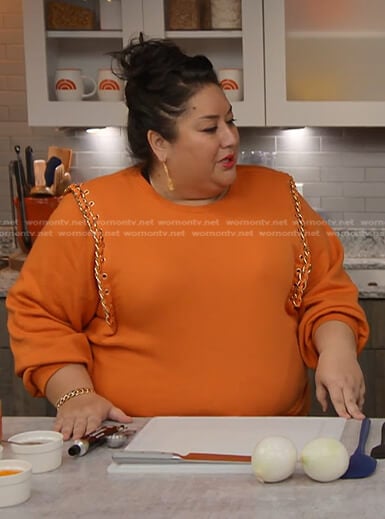 Ayesha Nurdjaja’s orange chain-trim sweatshirt on Today