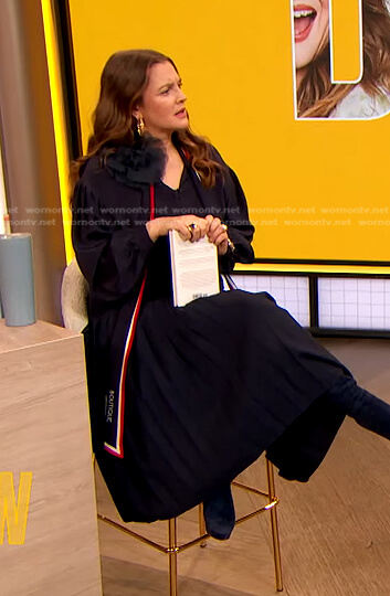 Drew’s navy tie neck blouse and pleated skirt on The Drew Barrymore Show