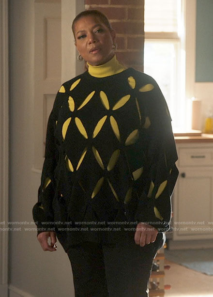 Robyn's black sweater with cutouts and spiral hoop earrings on The Equalizer