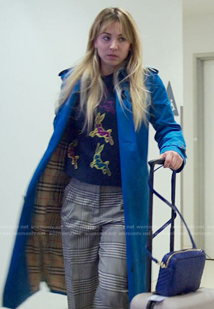 Cassie's cerulean blue trench coat, rabbit sweater and plaid pants on The Flight Attendant