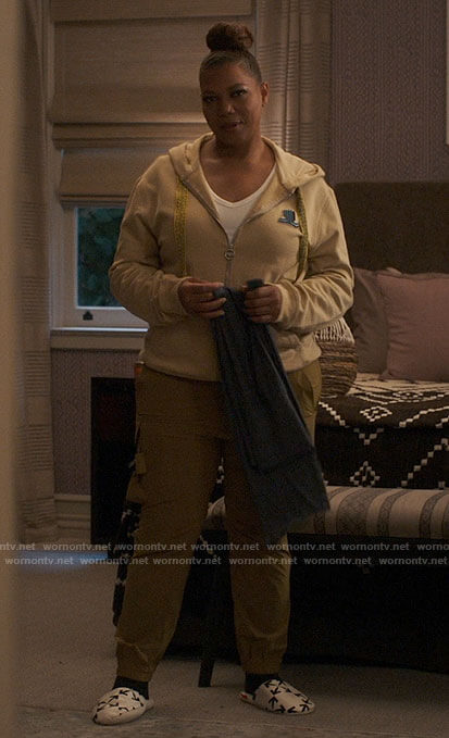 Robyn's beige logo patch hoodie and arrow slippers on The Equalizer