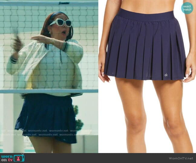 Alo Tennis Skirt in True Navy worn by Molly Novak (Maya Rudolph) on Loot