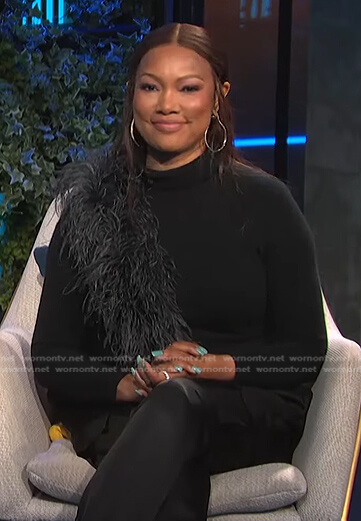 Garcelle's black feather trim sweater and satin pants on E! News Daily Pop