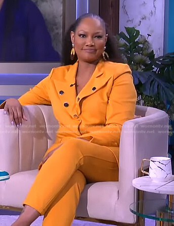 Garcelle’s orange button embellished blazer and pants on The Real
