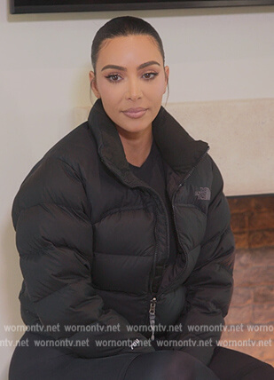 Kim's black puffer jacket and leggings on The Kardashians