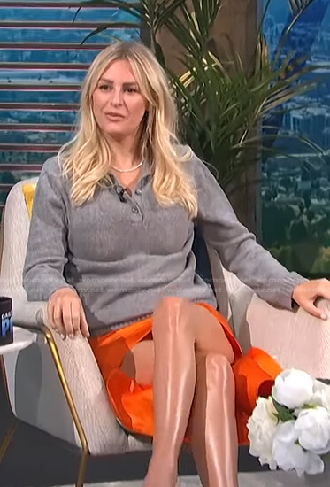Morgan’s grey polo sweater and orange skirt on E! News Daily Pop