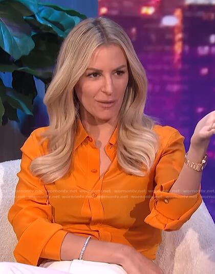 Morgan’s orange button down blouse on E! News Nightly Pop