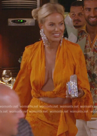 Caroline's orange twist blouse and skirt on The Real Housewives of Dubai
