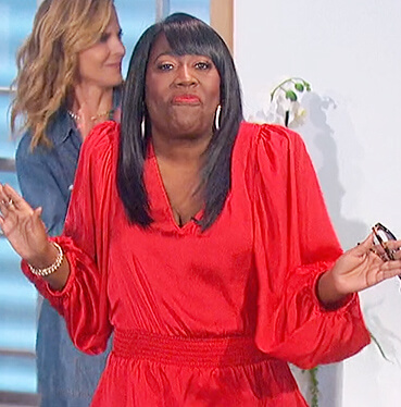 Sheryl’s red smocked waist top on The Talk