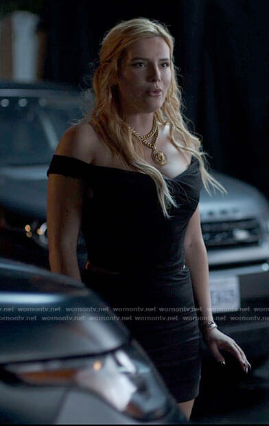 Marci's black off-shoulder top and large pendant necklace on American Horror Stories