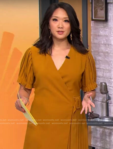 Nancy Chen’s mustard yellow pleated wrap dress on CBS Mornings
