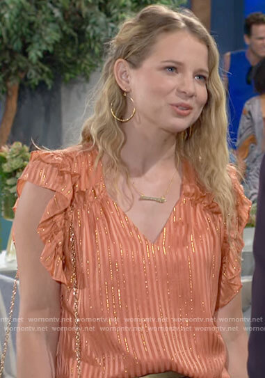 Summer's orange ruffled blouse with metallic stripes on The Young and the Restless