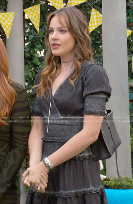Tessa's black smocked dress and studded bag on The Young and the Restless