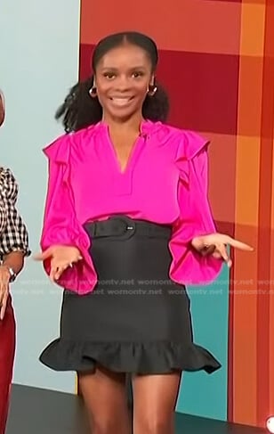 Zuri’s pink ruffle blouse and black belted skirt on Access Hollywood