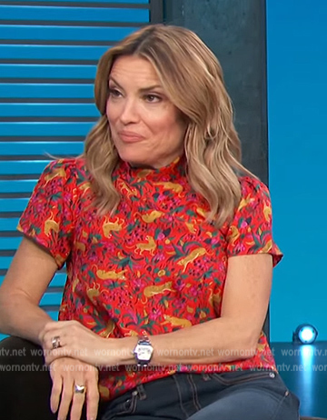 Kit’s red animal print short sleeve top on Access Hollywood
