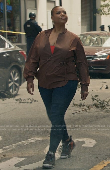Robyn’s brown tie waist top, V earrings and sneakers on The Equalizer