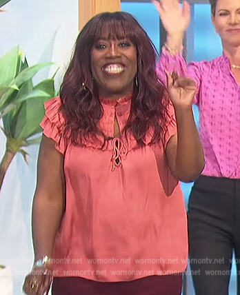 Sheryl’s coral satin ruffle blouse on The Talk