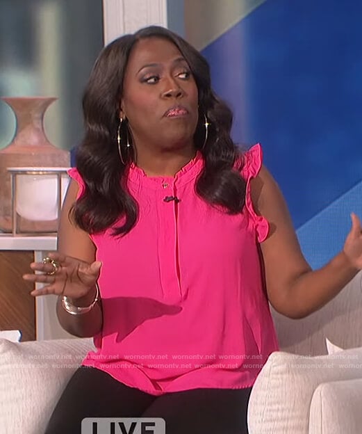 Sheryl's pink ruffle neck top on The Talk