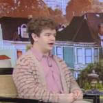 Gaten’s beige knit cardigan on Live with Kelly and Ryan