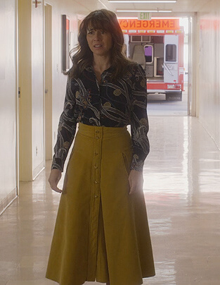 Judy’s black printed blouse and skirt on Dead to Me