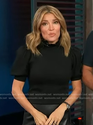 Kit's black puff sleeve top on Access Hollywood