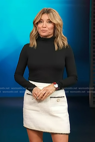 Kit's black turtleneck sweater and white mini skirt on Access Hollywood